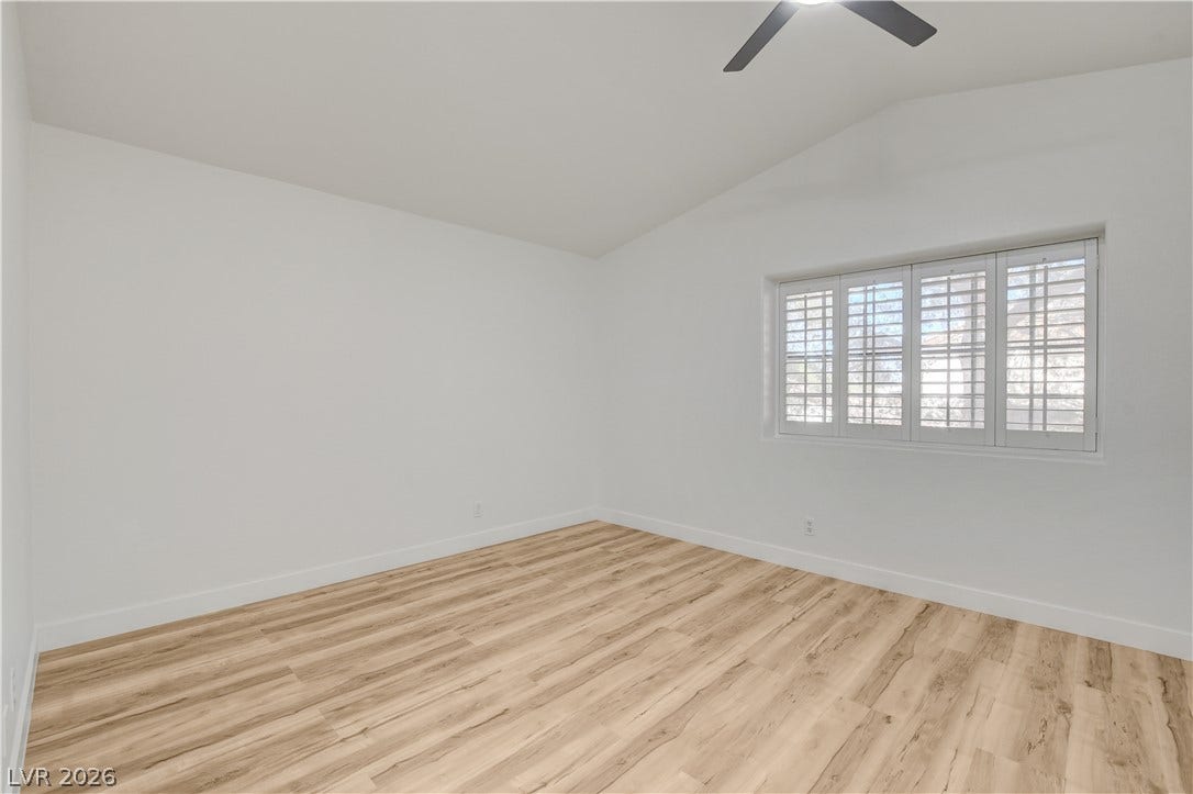 3676 Renovah Street, #205, Las Vegas, NV 89129 Vaulted ceilings and warm wood floors define this bright, versatile bedroom.