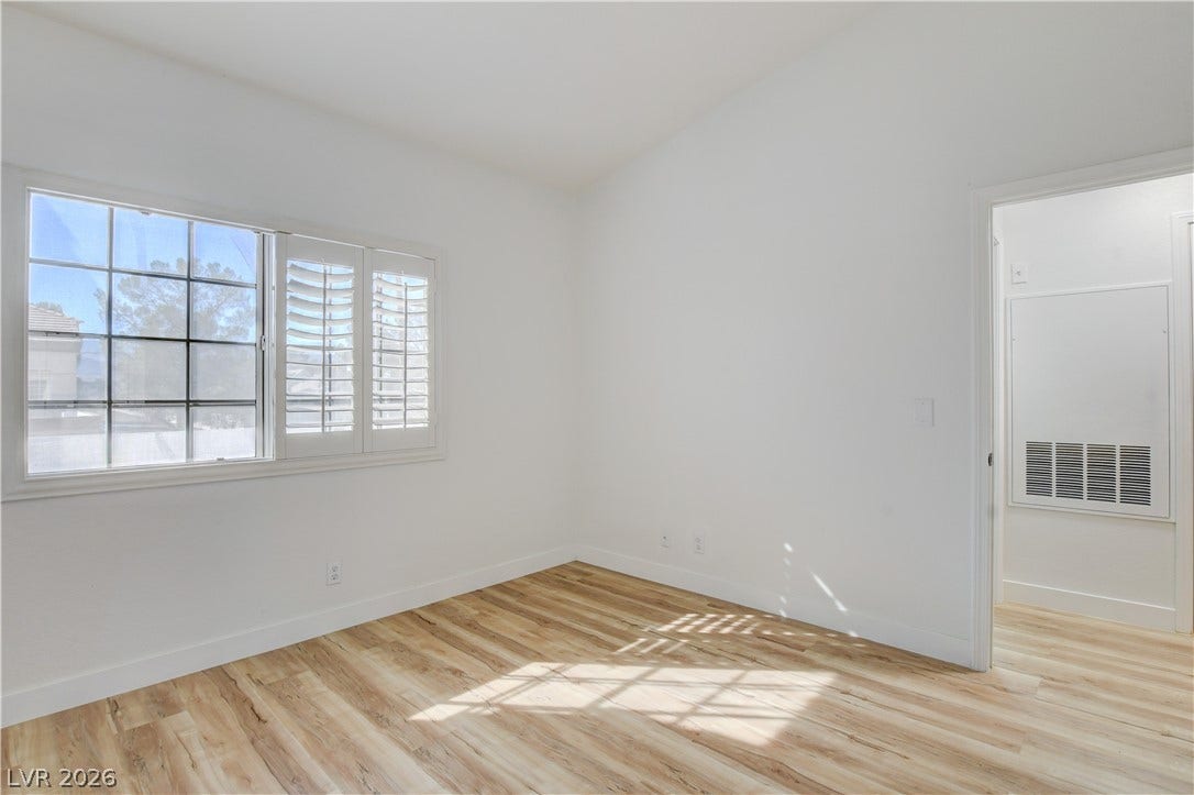 3676 Renovah Street, #205, Las Vegas, NV 89129 Gleaming wood-look floors pair beautifully with a classic shuttered window.
