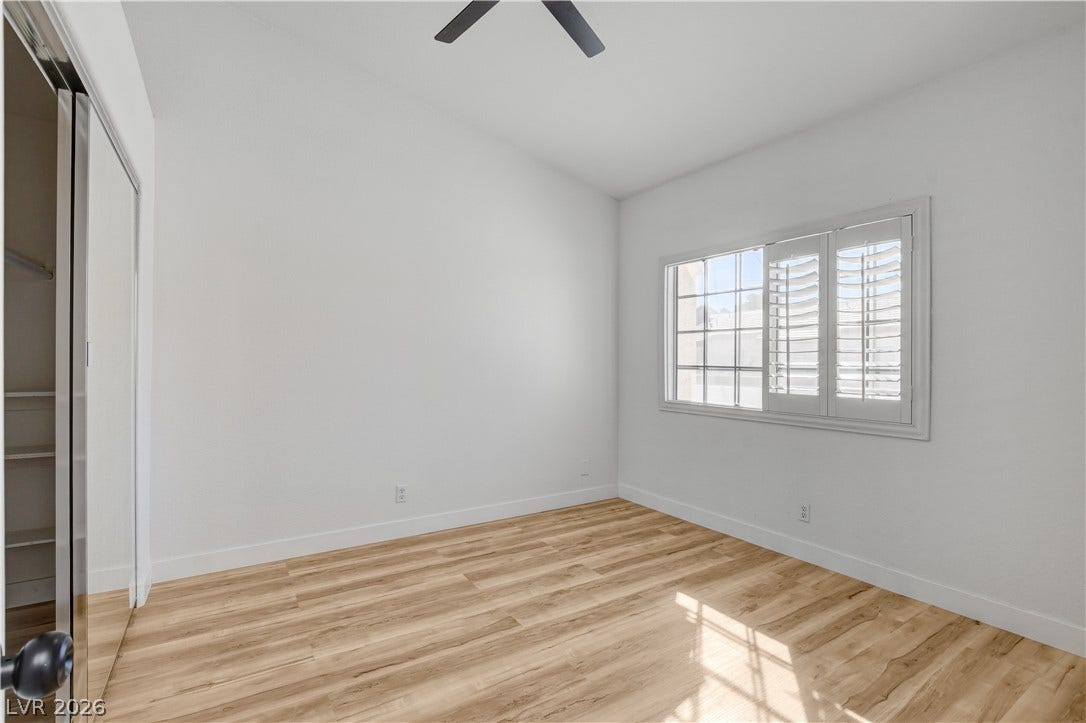 3676 Renovah Street, #205, Las Vegas, NV 89129 Rich wood flooring pairs elegantly with clean white walls and plantation shutters.