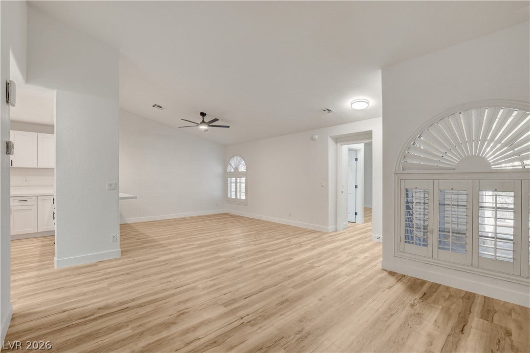 3676 Renovah Street, #205, Las Vegas, NV 89129 A spacious layout pairs clean white walls with classic plantation shutters and light wood floors.