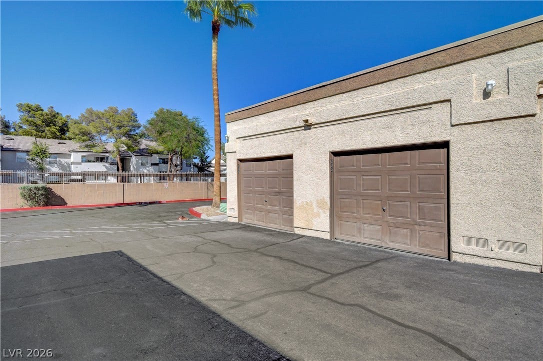 3676 Renovah Street, #205, Las Vegas, NV 89129 Stucco exteriors and detached garages define the rear of this community structure.
