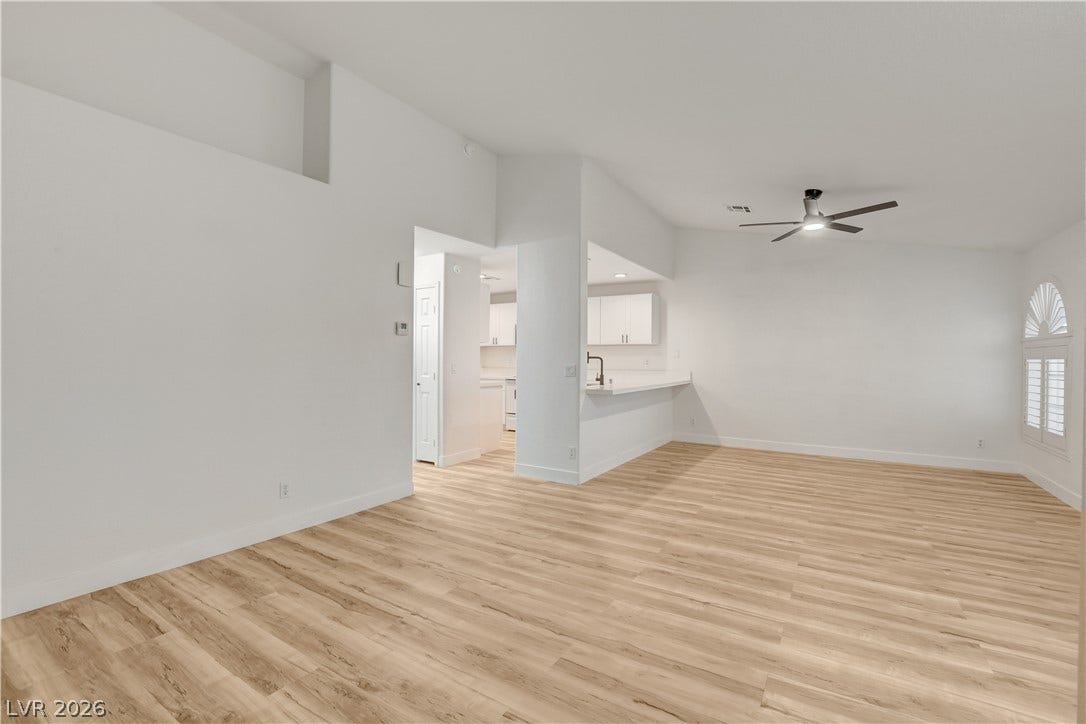 3676 Renovah Street, #205, Las Vegas, NV 89129 Warm wood flooring contrasts beautifully with crisp white walls in an airy open living space.