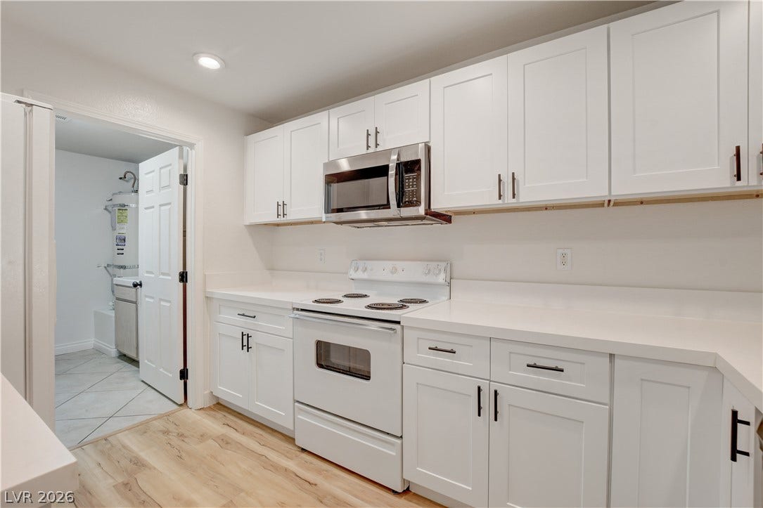 3676 Renovah Street, #205, Las Vegas, NV 89129 Crisp cabinetry and light wood-tone flooring define this modern, streamlined culinary space.