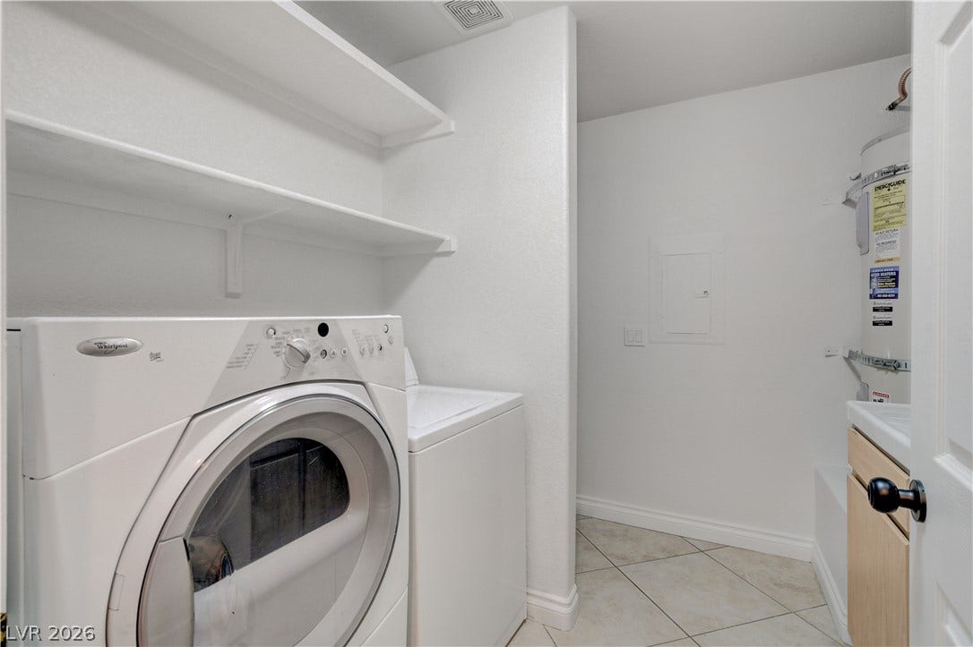 3676 Renovah Street, #205, Las Vegas, NV 89129 Built-in shelving and tile flooring maximize utility in this functional laundry room.