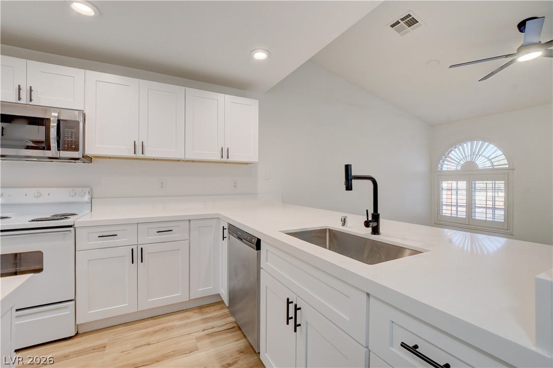 3676 Renovah Street, #205, Las Vegas, NV 89129 Gleaming stone countertops and modern shaker cabinetry anchor this freshly updated culinary space.