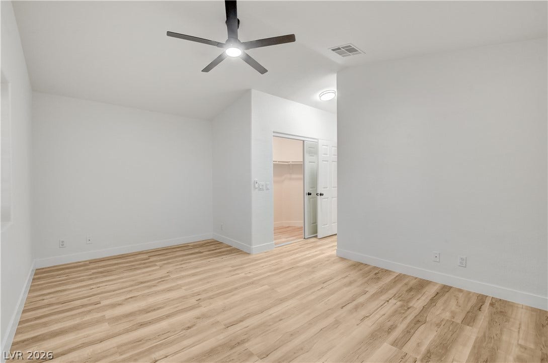 3676 Renovah Street, #205, Las Vegas, NV 89129 Vaulted ceilings and warm wood floors define this spacious bedroom.