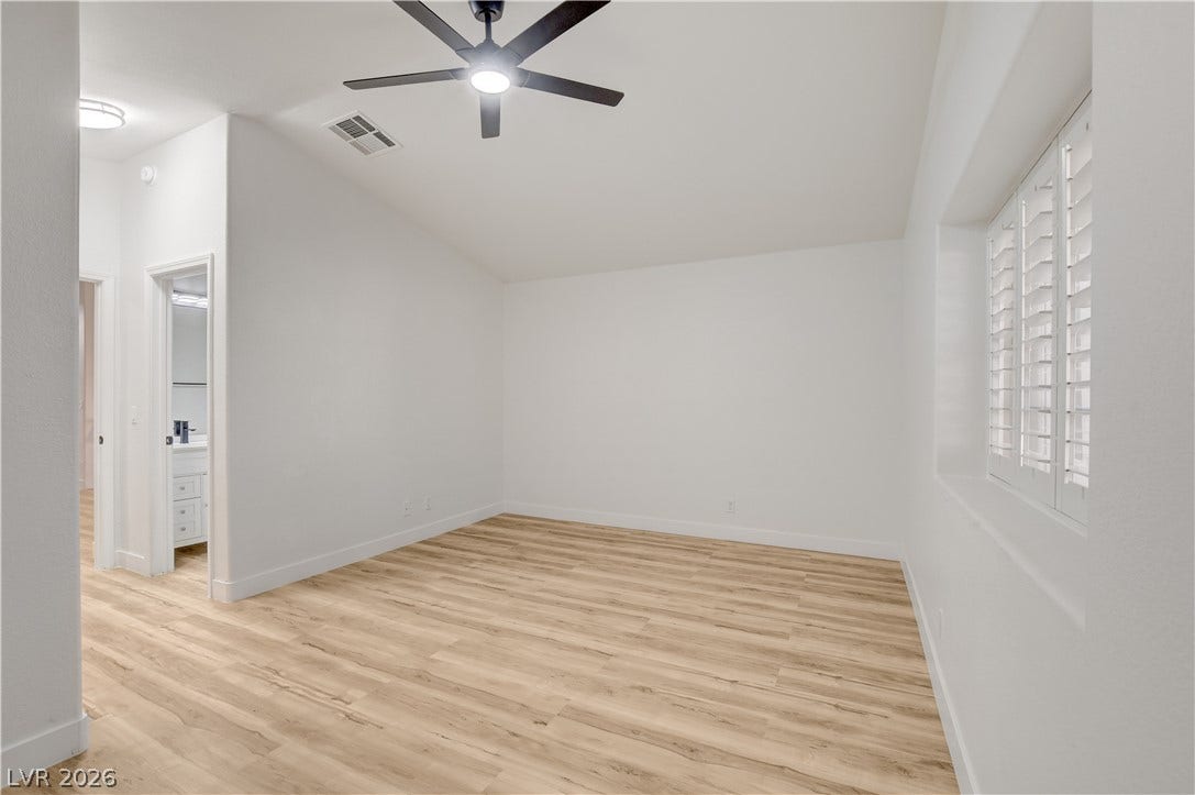 3676 Renovah Street, #205, Las Vegas, NV 89129 Vaulted ceilings and wide-plank wood flooring define this versatile bedroom space.