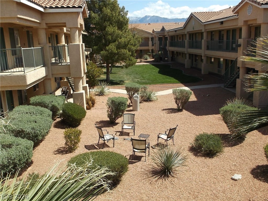 100 Pulsipher Lane, #1205, Mesquite, NV 89027 Landscaped courtyard pathways weave past Spanish tile roofs with a mountain backdrop.