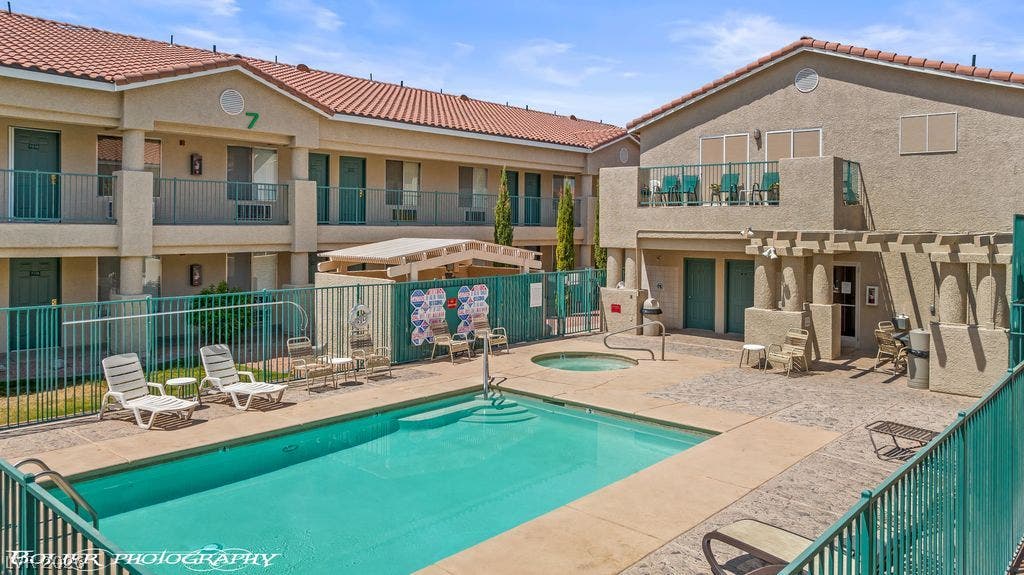 100 Pulsipher Lane, #1205, Mesquite, NV 89027 An inviting community swimming pool and spa are surrounded by classic stucco architecture.
