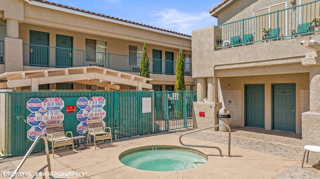 100 Pulsipher Lane, #1205, Mesquite, NV 89027 A sparkling in-ground spa sits enclosed by safety fencing under clear desert skies.