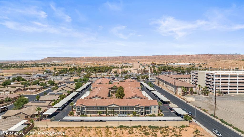100 Pulsipher Lane, #1205, Mesquite, NV 89027 An elevated perspective captures the residential complex with surrounding desert bluffs on the horizon.