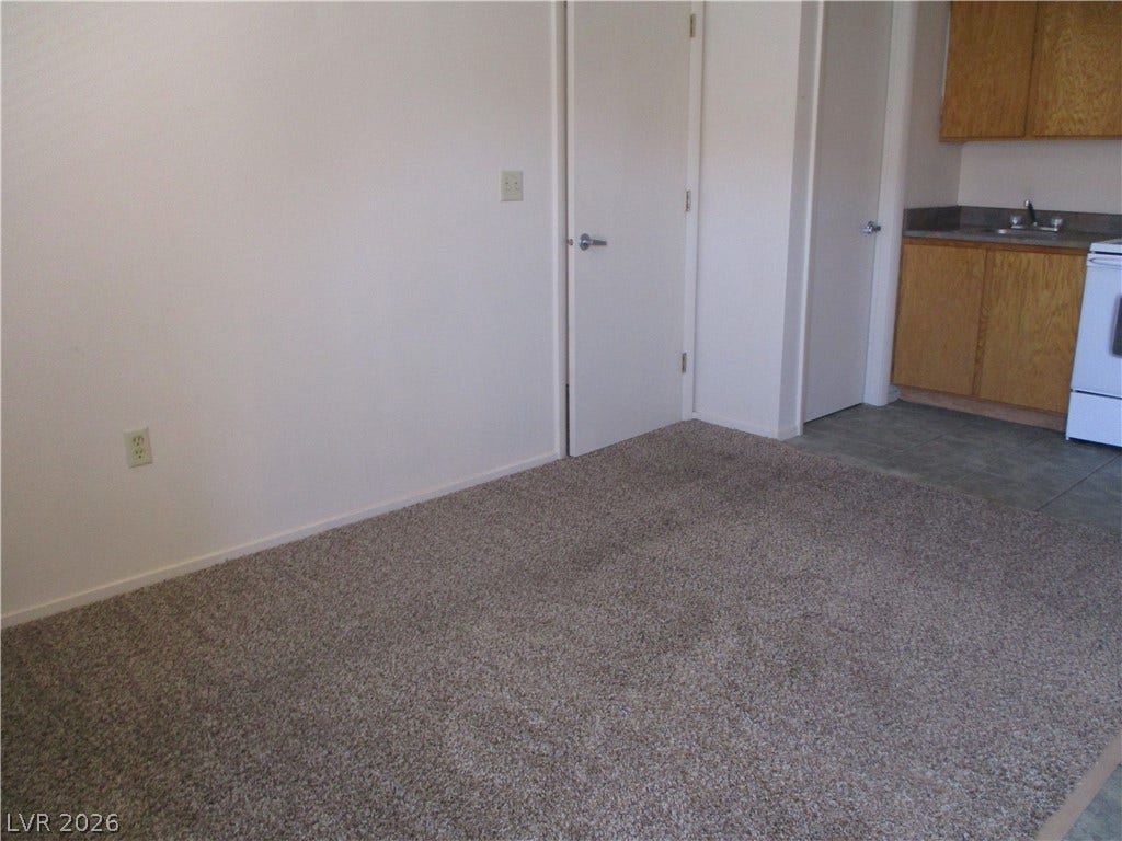 100 Pulsipher Lane, #1205, Mesquite, NV 89027 Plush carpeting defines the versatile living space adjacent to a functional kitchen area.