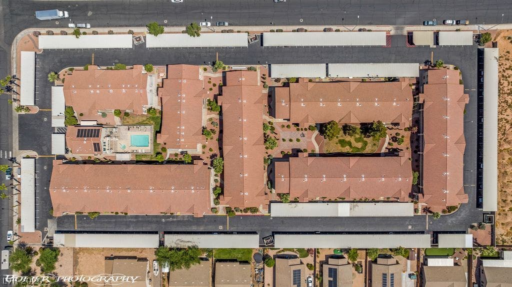 100 Pulsipher Lane, #1205, Mesquite, NV 89027 An aerial view showcases the structured community layout with tile roofing and paved parking spaces.
