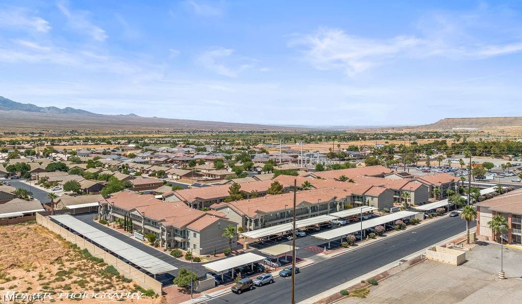 100 Pulsipher Lane, #1205, Mesquite, NV 89027 An aerial perspective showcases a residential neighborhood nestled against a scenic mountain backdrop.