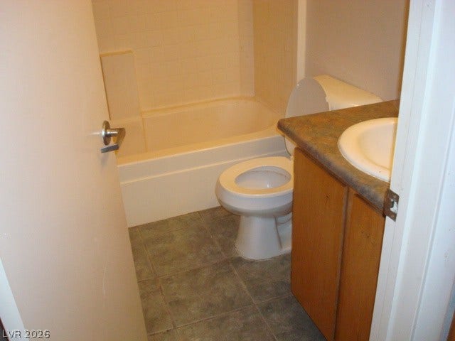 100 Pulsipher Lane, #1205, Mesquite, NV 89027 Tiled flooring and a classic vanity setup anchor this functional bathroom space.