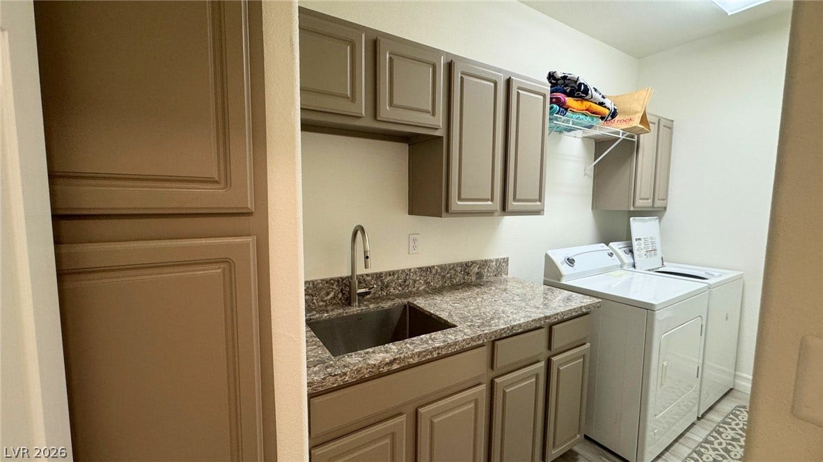 8304 Apple Glaze Avenue, #203, Las Vegas, NV 89145 Ample cabinetry and stone-look countertops anchor this functional laundry space with an integrated utility sink.