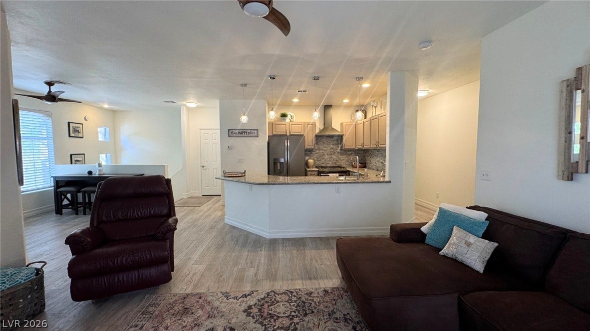 8304 Apple Glaze Avenue, #203, Las Vegas, NV 89145 An open floor plan seamlessly connects the central kitchen with the surrounding living spaces.