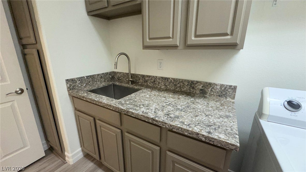 8304 Apple Glaze Avenue, #203, Las Vegas, NV 89145 Ample counter space and built-in cabinetry enhance this functional utility setup.