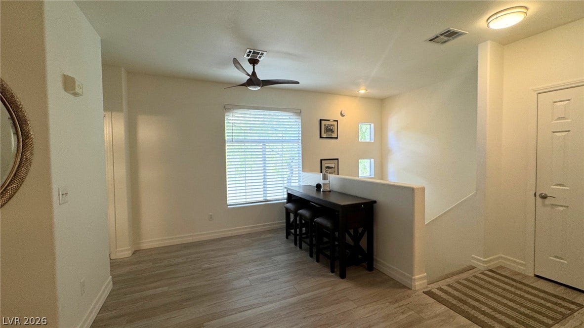8304 Apple Glaze Avenue, #203, Las Vegas, NV 89145 Gleaming wood-look floors complement the light-filled layout with a welcoming staircase entry.