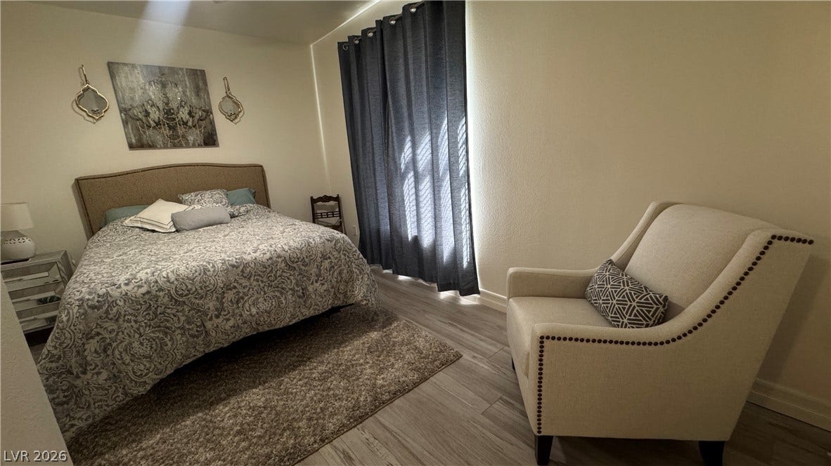 8304 Apple Glaze Avenue, #203, Las Vegas, NV 89145 Smooth wood-grain flooring and high-reaching windows create a restful atmosphere.