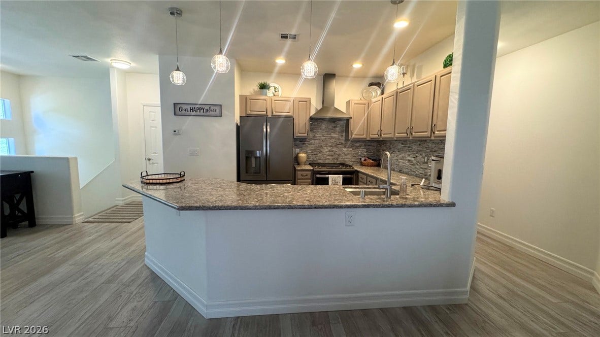 8304 Apple Glaze Avenue, #203, Las Vegas, NV 89145 Polished stone countertops and seamless wood-look flooring define this open culinary space.