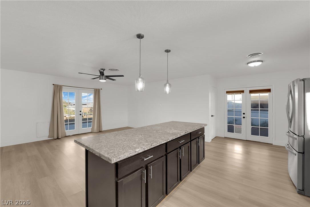 419 Scenic Drive, Henderson, NV 89002 French doors open to the outdoors from this airy kitchen layout featuring wood floors.