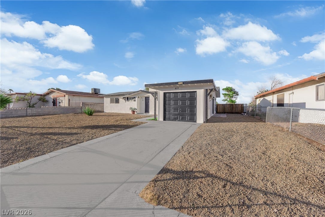 419 Scenic Drive, Henderson, NV 89002 A long concrete driveway leads to the detached garage of this classic suburban residence.