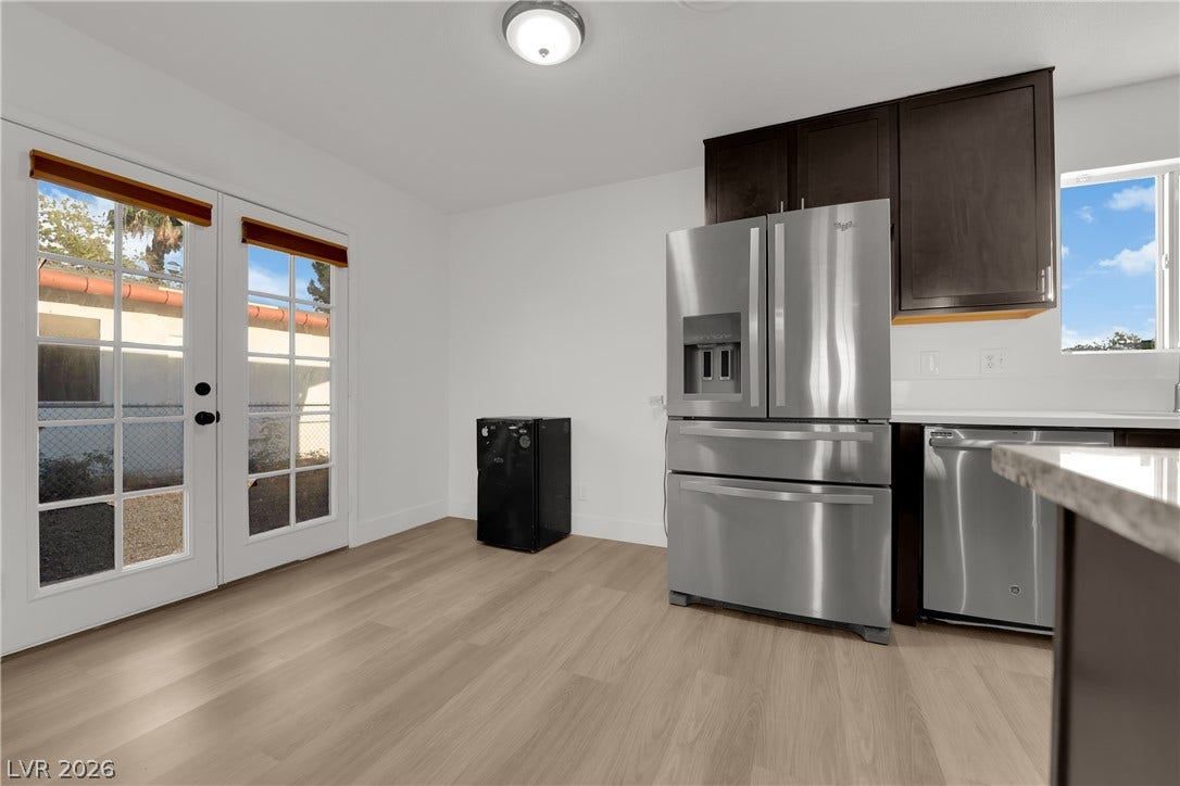 419 Scenic Drive, Henderson, NV 89002 Glass-paneled French doors open to the outdoors alongside this modern, light-filled kitchen space.