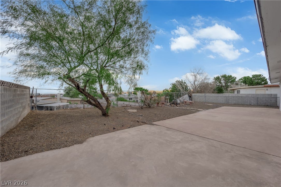 419 Scenic Drive, Henderson, NV 89002 An expansive concrete patio overlooks the low-maintenance backyard enclosed by block fencing.