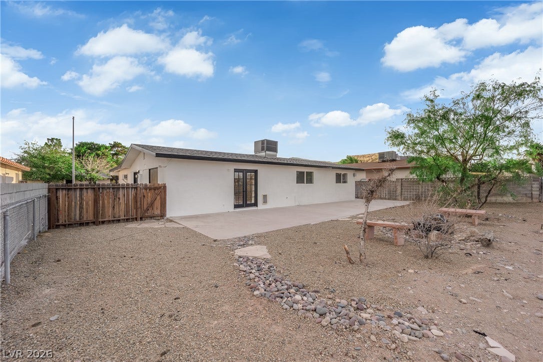 419 Scenic Drive, Henderson, NV 89002 An expansive gravel yard features a large concrete patio under open desert skies.