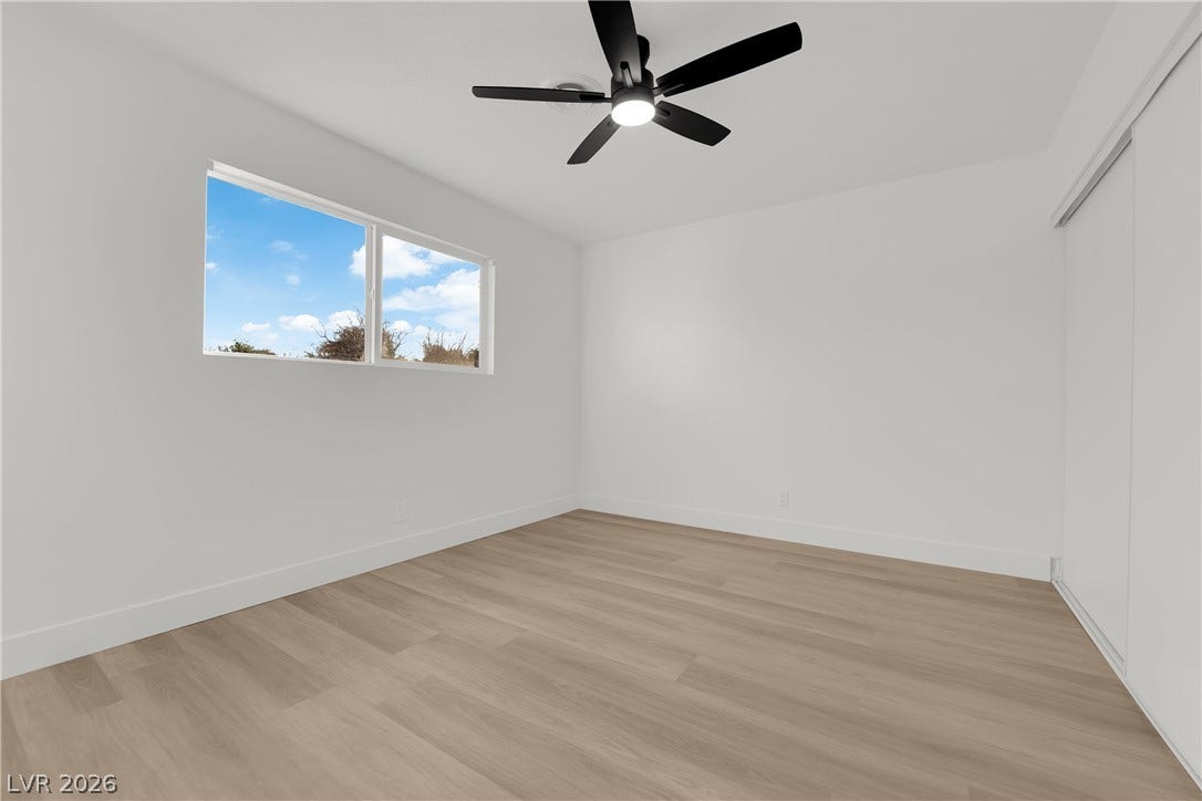 419 Scenic Drive, Henderson, NV 89002 Clean lines and light wood flooring define this serene bedroom space.