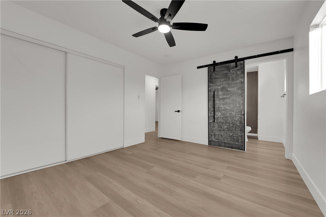 419 Scenic Drive, Henderson, NV 89002 Smooth wood floors and crisp white walls create a clean contemporary aesthetic in this bedroom.