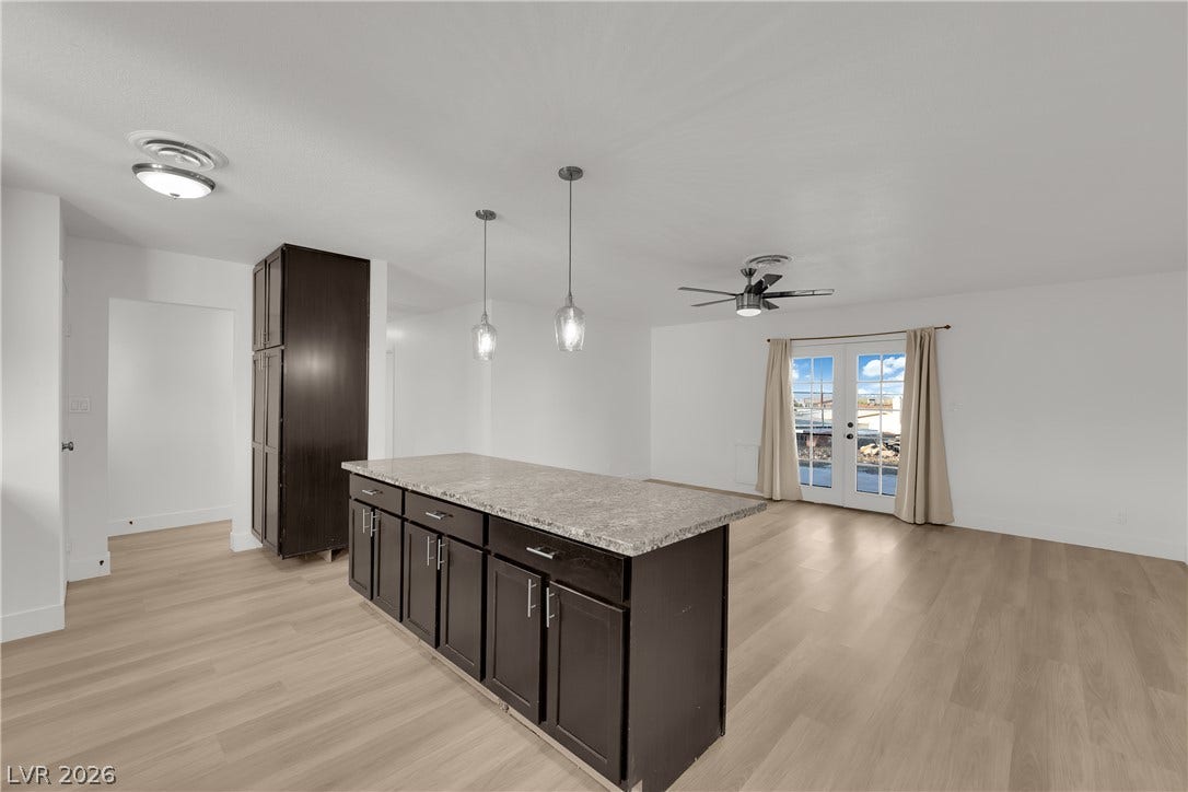 419 Scenic Drive, Henderson, NV 89002 An open floorplan seamlessly connects the stone-countertop kitchen island with a bright living area.