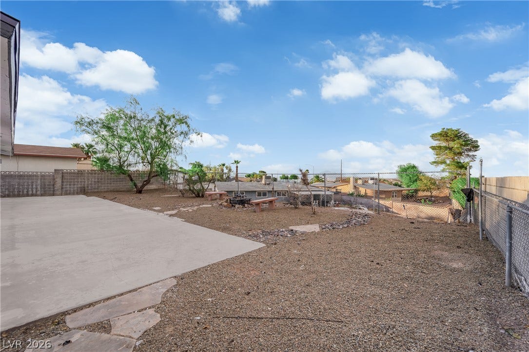 419 Scenic Drive, Henderson, NV 89002 A spacious backyard area includes a large concrete patio alongside low-maintenance gravel landscaping.