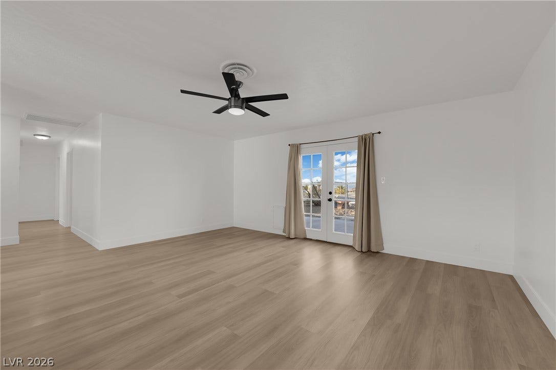 419 Scenic Drive, Henderson, NV 89002 Smooth wood floors anchor this open living area featuring classic French doors to the outdoors.