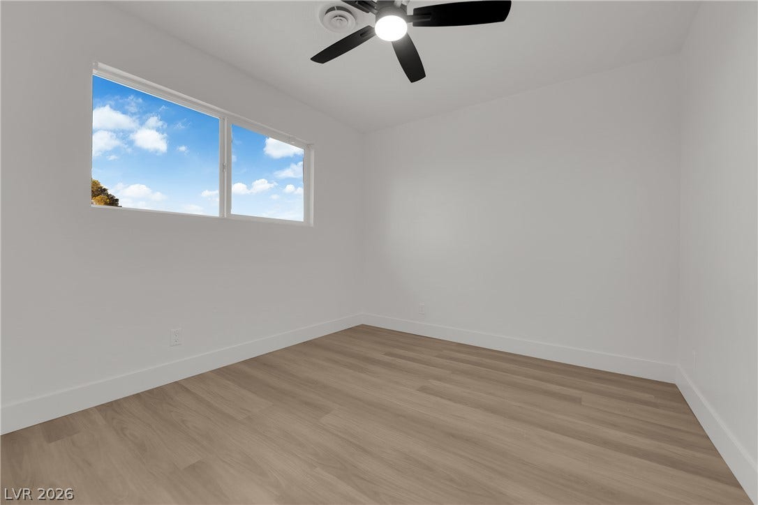 419 Scenic Drive, Henderson, NV 89002 Smooth wood-look flooring and crisp white walls define this versatile secondary bedroom space.
