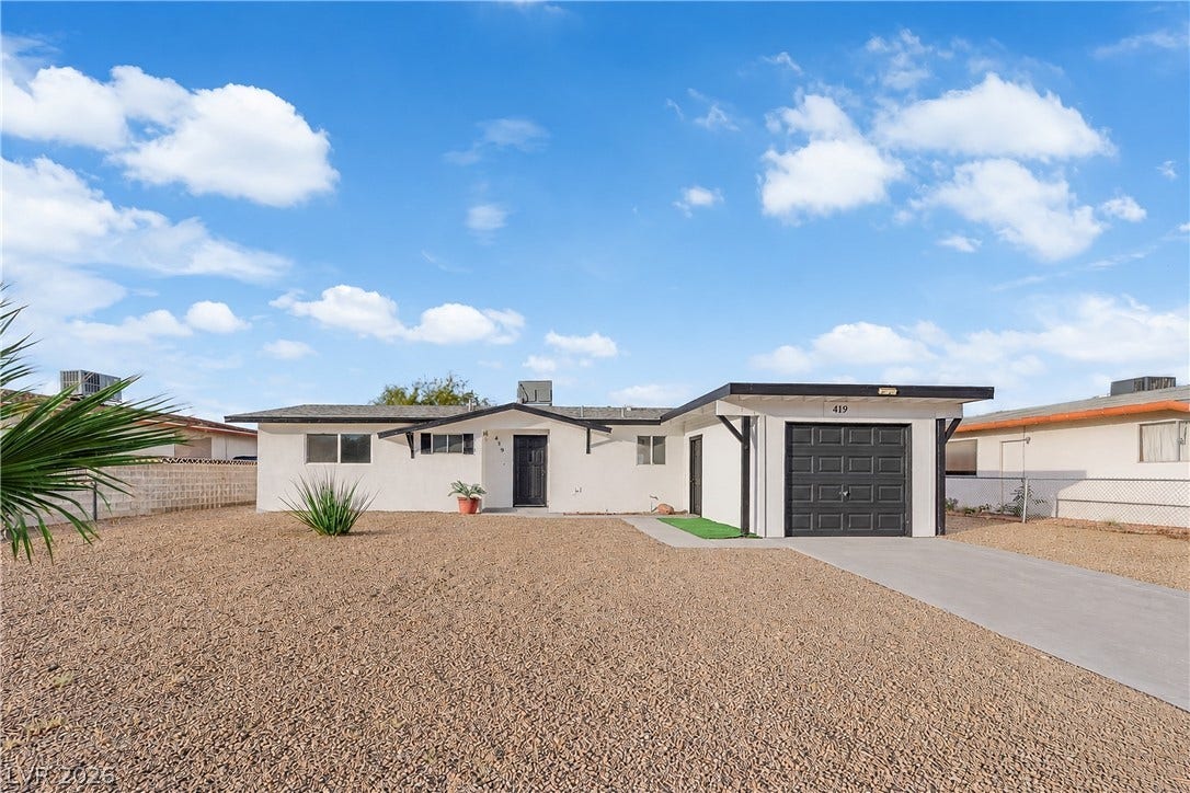 419 Scenic Drive, Henderson, NV 89002 A classic ranch exterior pairs low-maintenance desert landscaping with a clean concrete driveway.