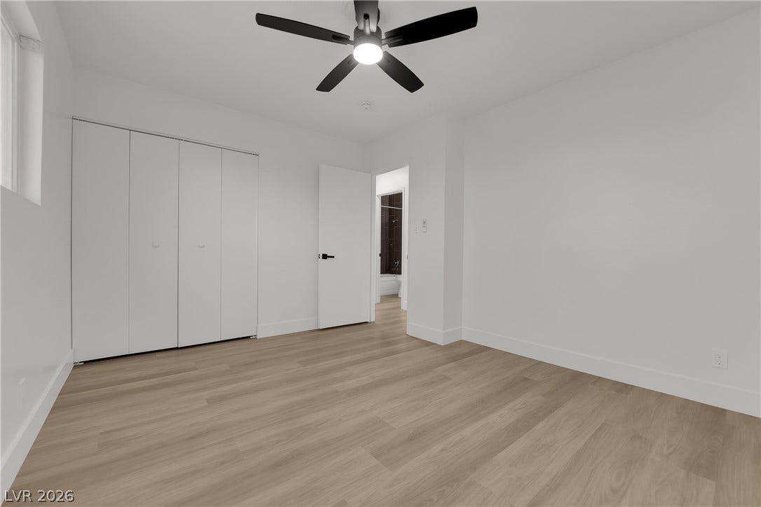 419 Scenic Drive, Henderson, NV 89002 Smooth wood-look flooring and crisp white walls create a minimalist canvas in this bedroom.