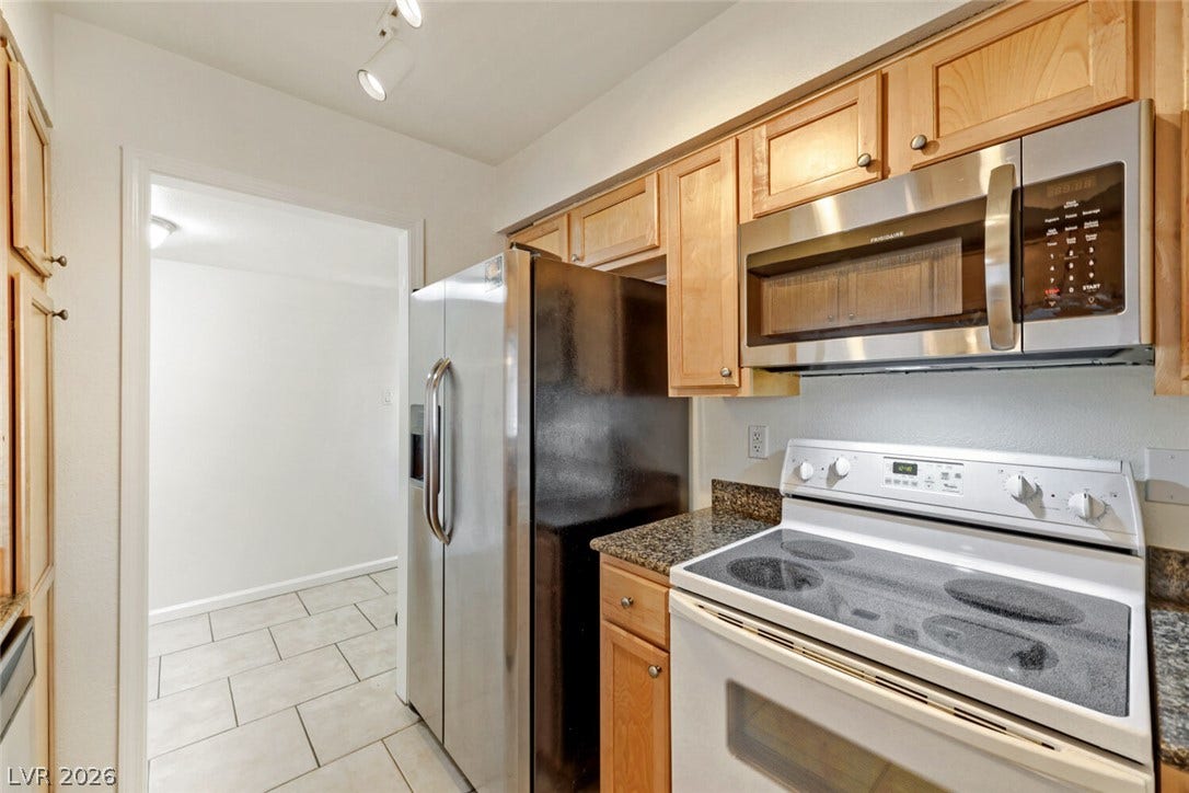 769 Oakmont Avenue, #403, Las Vegas, NV 89109 Gleaming stone countertops and classic wood cabinetry enrich this functional cooking space.