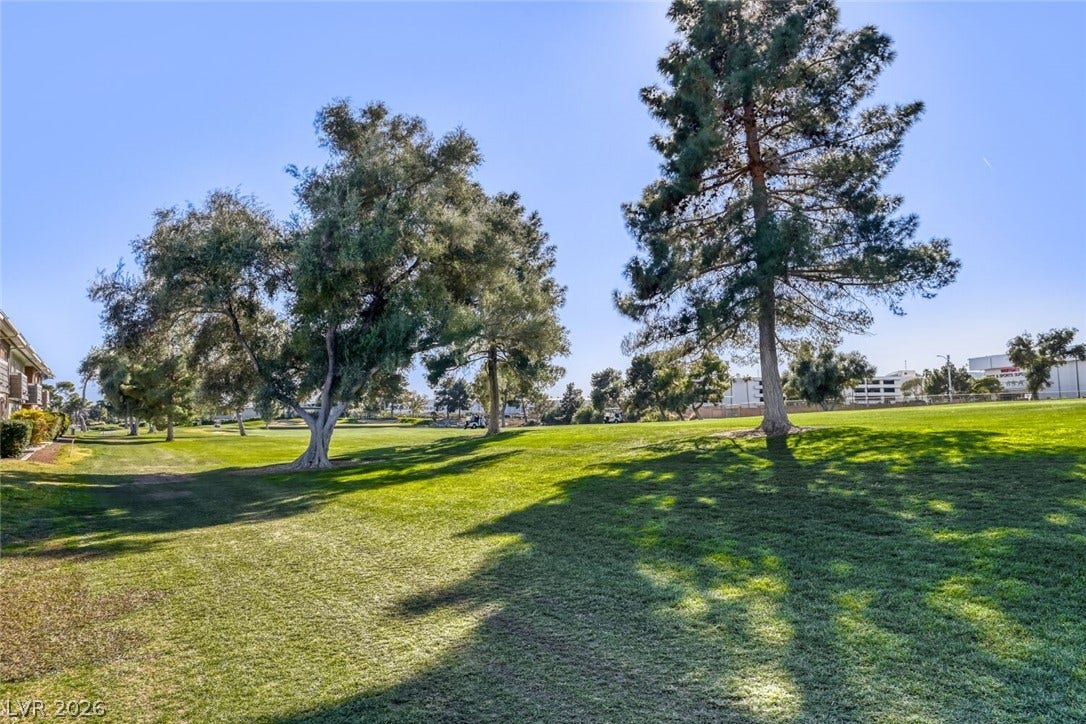 769 Oakmont Avenue, #403, Las Vegas, NV 89109 Mature shade trees dot the rolling green lawns of this golf course property.