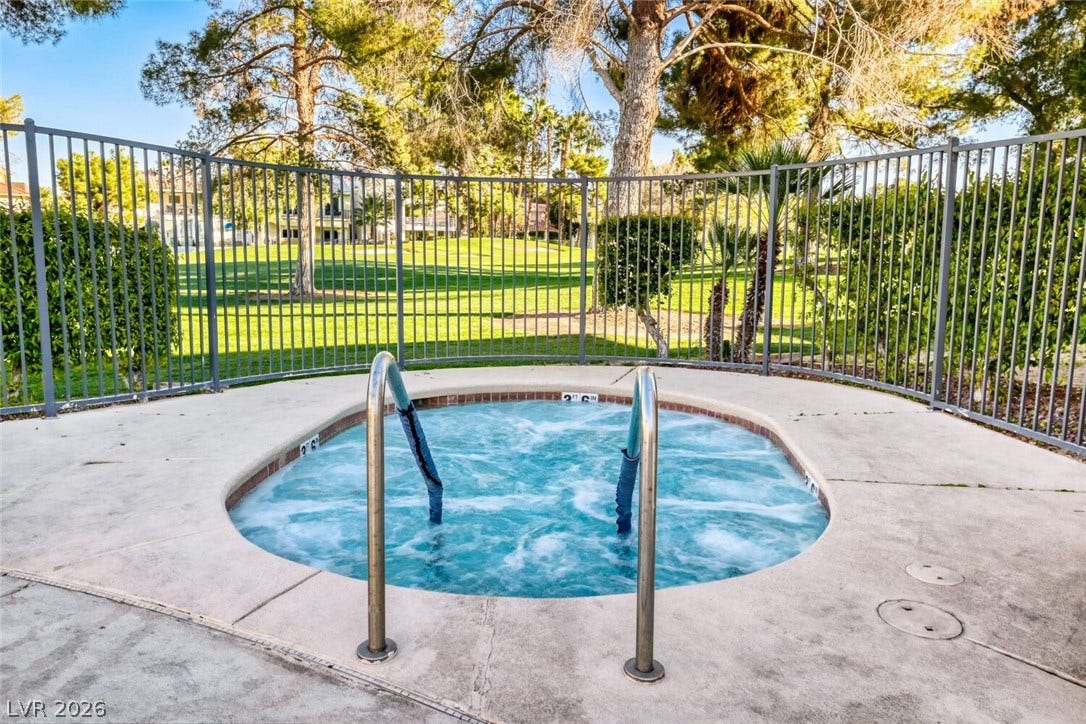 769 Oakmont Avenue, #403, Las Vegas, NV 89109 An inviting in-ground spa sits surrounded by concrete decking and protective metal fencing.