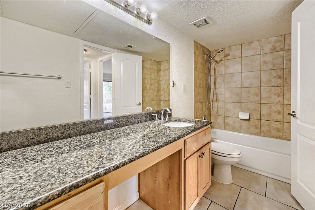 769 Oakmont Avenue, #403, Las Vegas, NV 89109 Polished granite countertops and tiled tub surrounds.