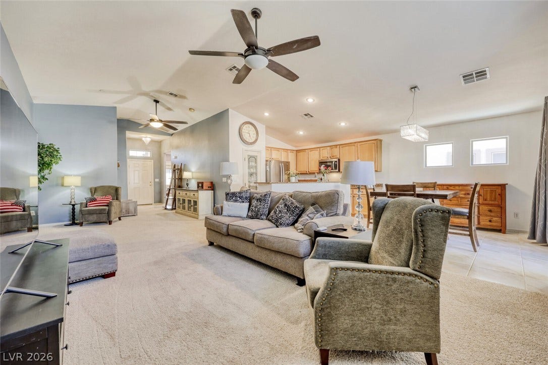 5817 Hawkeye Bell Street, North Las Vegas, NV 89081 An open floorplan design seamlessly connects the carpeted living space to the adjacent dining area.
