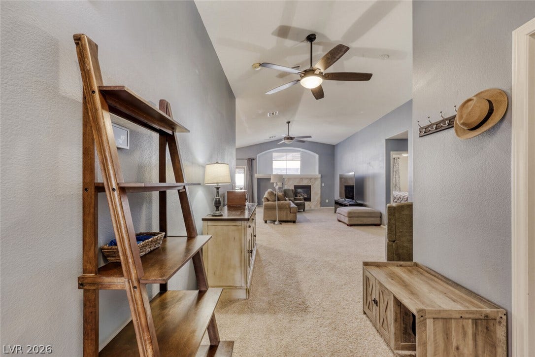 5817 Hawkeye Bell Street, North Las Vegas, NV 89081 Vaulted ceilings and soft carpeting enhance this welcoming entry hall leading to the living spaces.