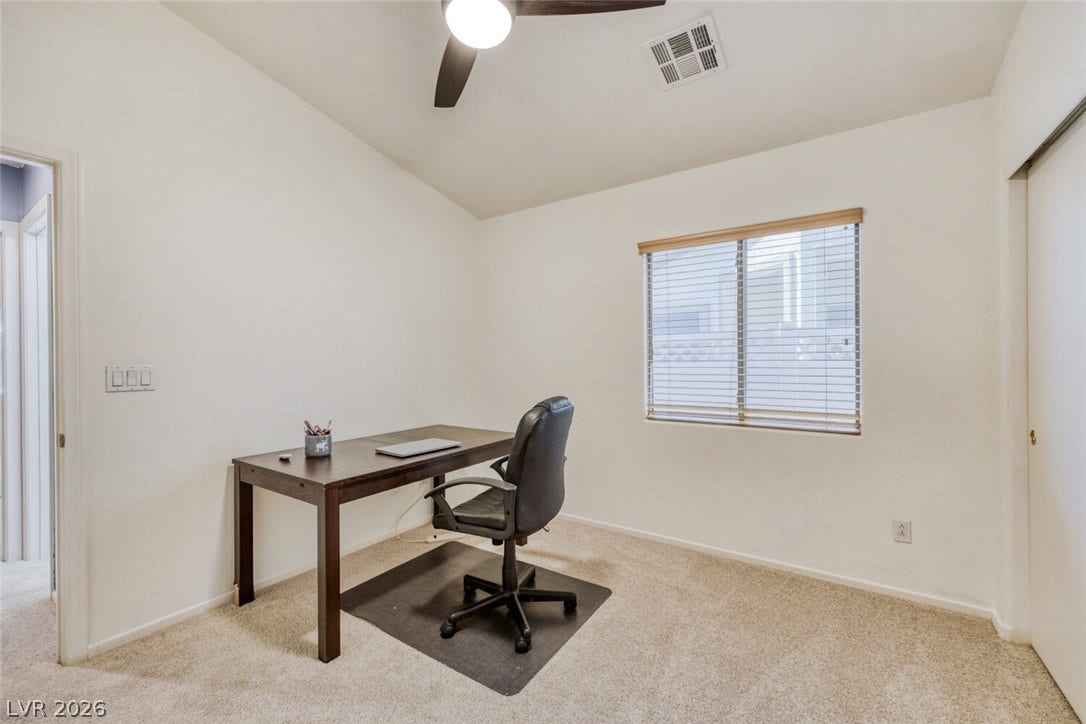 5817 Hawkeye Bell Street, North Las Vegas, NV 89081 Soft carpeting pairs with natural light from a large window in this quiet workspace.
