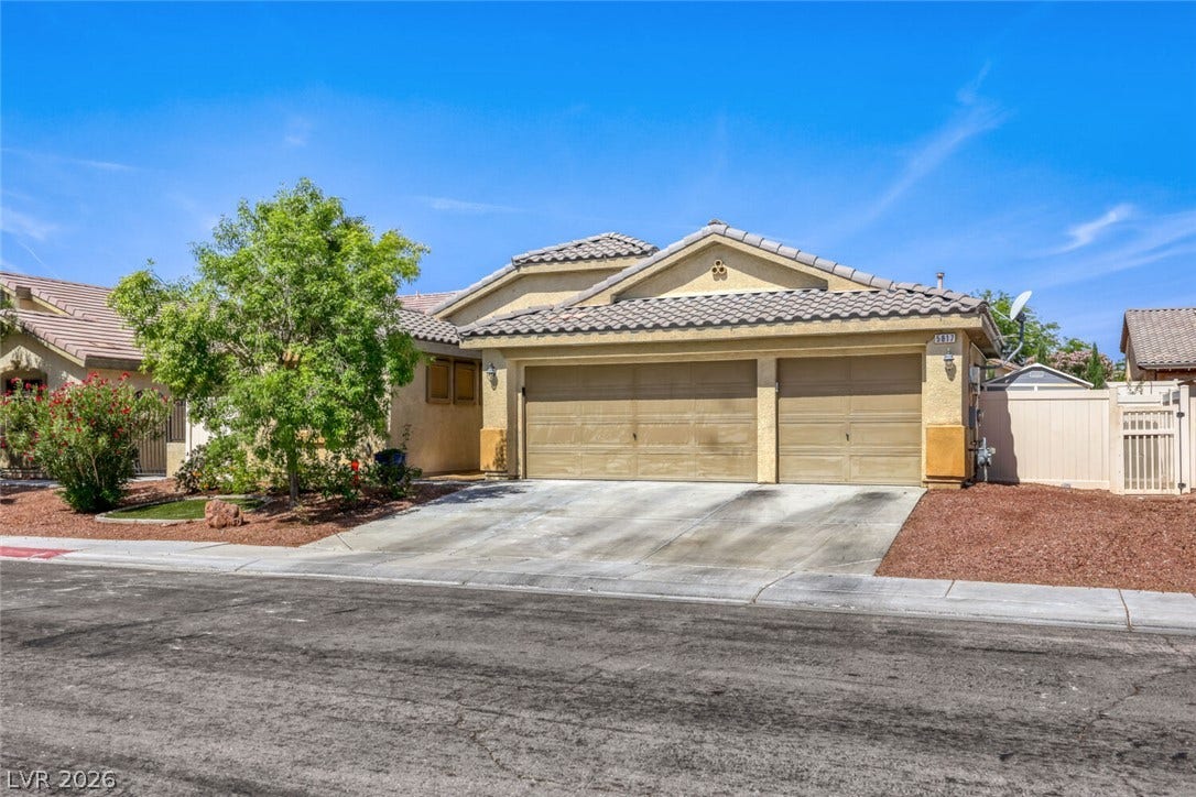 5817 Hawkeye Bell Street, North Las Vegas, NV 89081 An inviting stucco exterior features tiled roofing alongside a spacious concrete driveway.
