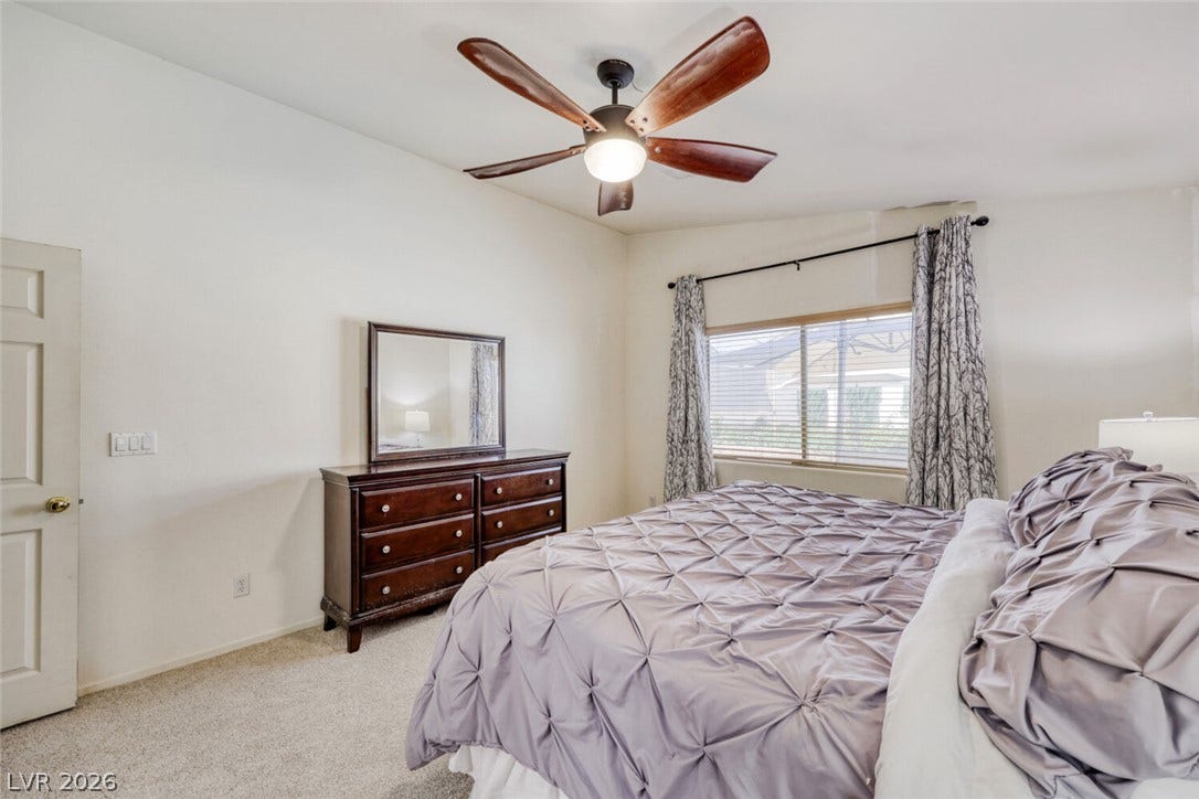 5817 Hawkeye Bell Street, North Las Vegas, NV 89081 Natural light fills this bedroom complete with neutral carpeting and a wide window.