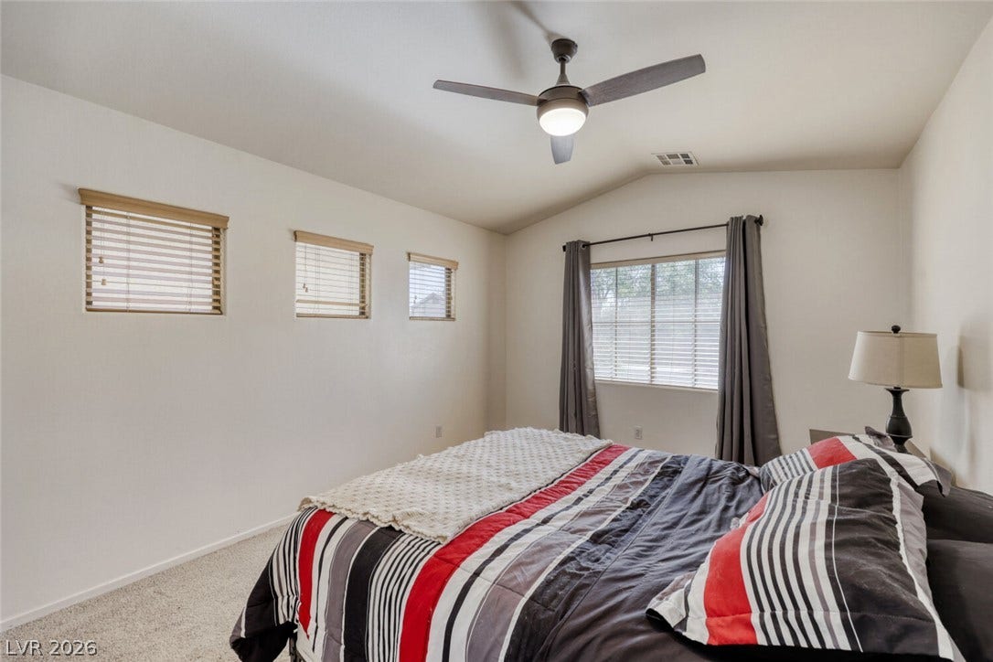 5817 Hawkeye Bell Street, North Las Vegas, NV 89081 Vaulted ceilings and plush carpeting define this serene sleeping space.