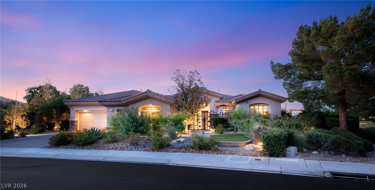 6 Brookridge Drive, Henderson, NV 89052 Manicured landscaping accents the front of this single-story stucco residence under a twilight sky.