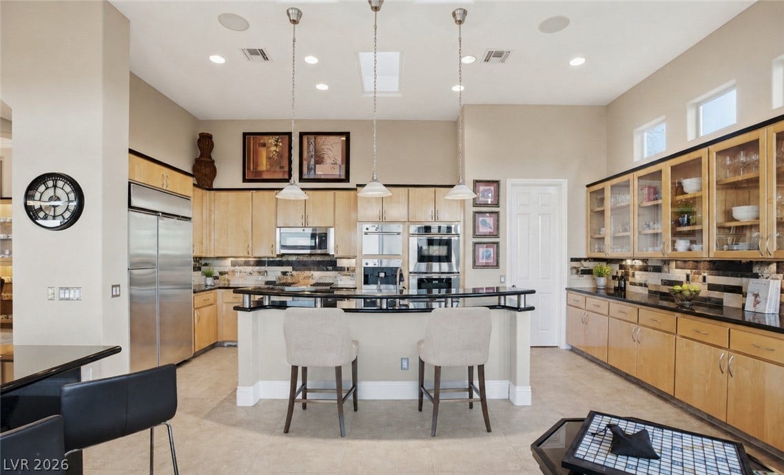 6 Brookridge Drive, Henderson, NV 89052 Gleaming stone countertops and warm wood cabinetry define this gourmet cooking and dining space.